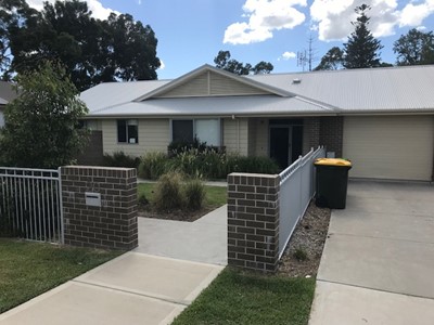 Self-contained unit in Lifestyle Solutions Specialist Disability Accommodation in Argenton, Newcastle, NSW, showing fully accessible pavement entry to unit front door and garage area