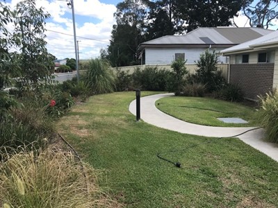 Self-contained unit in Lifestyle Solutions Specialist Disability Accommodation in Argenton, Newcastle, NSW, showing fully accessible front garden with lawn