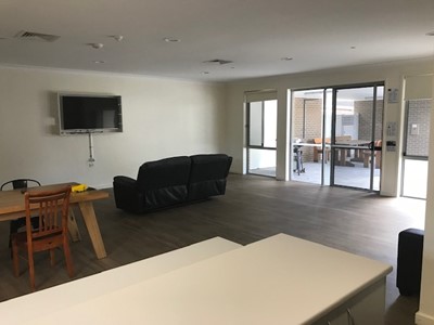 Accessible living area in self-contained unit in Lifestyle Solutions Specialist Disability Accommodation in Argenton, Newcastle, NSW.