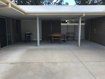Accessible communal outdoor area with BBQ for self-contained units in Lifestyle Solutions Specialist Disability Accommodation in Argenton, Newcastle, NSW