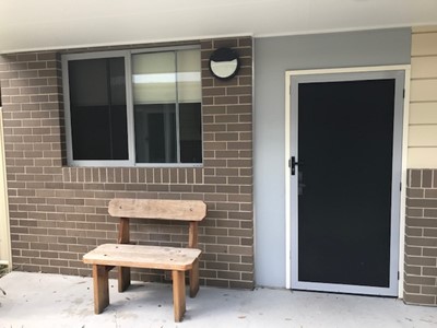 Outdoor seating outside self-contained unit in Lifestyle Solutions Specialist Disability Accommodation in Argenton, Newcastle, NSW