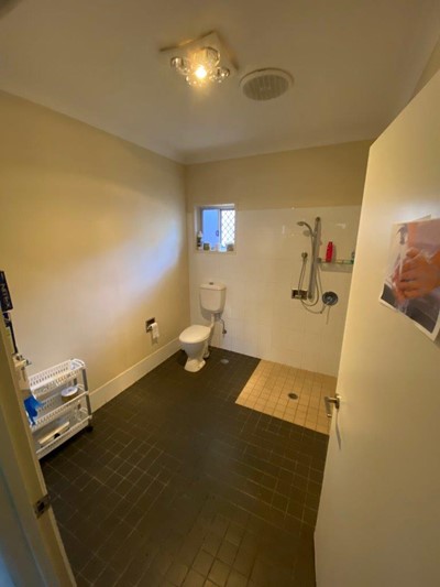 Accessible toilet and shower in bathroom in Lifestyle Solutions four-bedroom Supported Independent Living (SIL) house in Silkstone, Qld