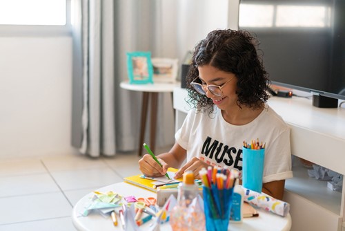 Teenage Girl in foster care colouring in