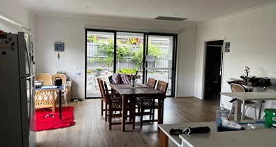 Dining area and kitchen leading to accessible outdoor area in Lifestyle Solutions three-bedroom Specialist Disability Accommodation (SDA) in Pallara, Qld