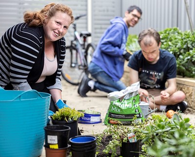 Residents putting plants in garden in Lifestyle Solutions Supported Independent Living property in Albion Park Rail, NSW