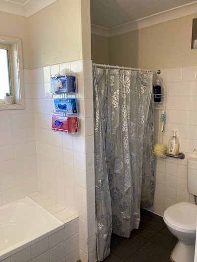 Bathroom showing toilet, shower and bath in Lifestyle Solutions two-bedroom Supported Independent Living accommodation in Warabrook, NSW
