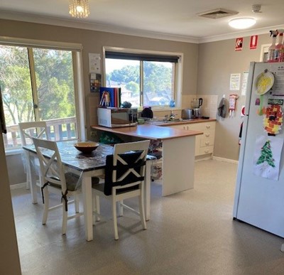 Dining area and kitchen in two-bedroom Lifestyle Solutions Supported Independent Living accommodation in Warabrook, NSW