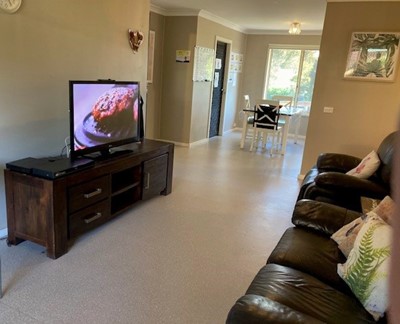 Living room in Lifestyle Solutions two-bedroom Supported Independent Living accommodation in Warabrook, NSW
