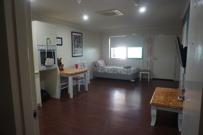 Open plan living, dining and sleeping area in self-contained apartment  at Lifestyle Solutions Supported Independent Living property in Wyong, NSW
