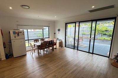 Dining area leading to outdoor entertainment area in Lifestyle Solutions three-bedroom Specialist Disability Accommodation (SDA) in Pallara, Qld