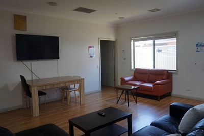 Communal lounge and TV in Lifestyle Solutions Supported Independent Living property with two self-contained villas in Fairfield, Sydney