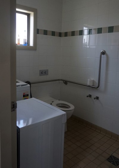 Bathroom and laundry with hand rails in villa in Lifestyle Solutions Supported Independent Living property with two self-contained villas in Fairfield, Sydney