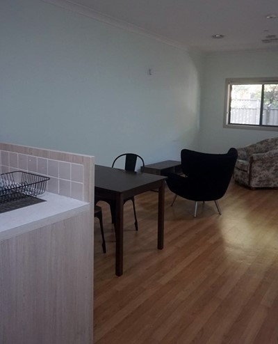 Villa living area and kitchen in Lifestyle Solutions Supported Independent Living property with two self-contained villas in Fairfield, Sydney