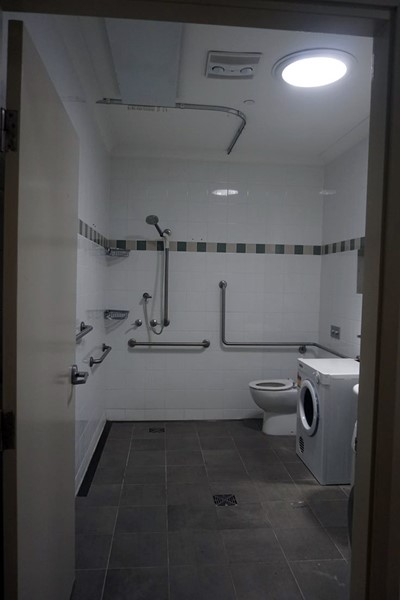 Villa bathroom and laundry with handrails in Lifestyle Solutions Supported Independent Living property with two self-contained villas in Fairfield, Sydney