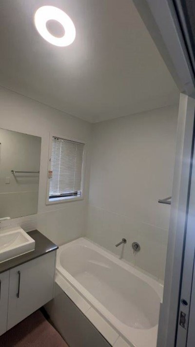 Bathroom showing bath and sink in Lifestyle Solutions Supported Independent Living accommodation in Pallara, Qld